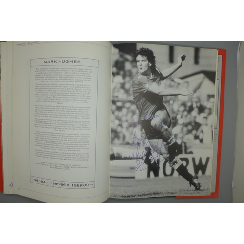 702 - Manchester United; a player by player book containing approximately 97 signatures from former player... 