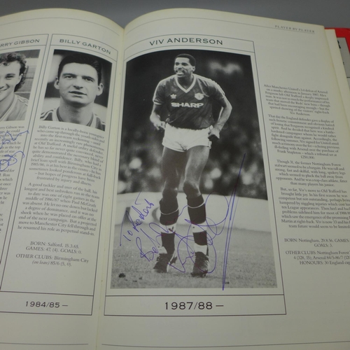 702 - Manchester United; a player by player book containing approximately 97 signatures from former player... 