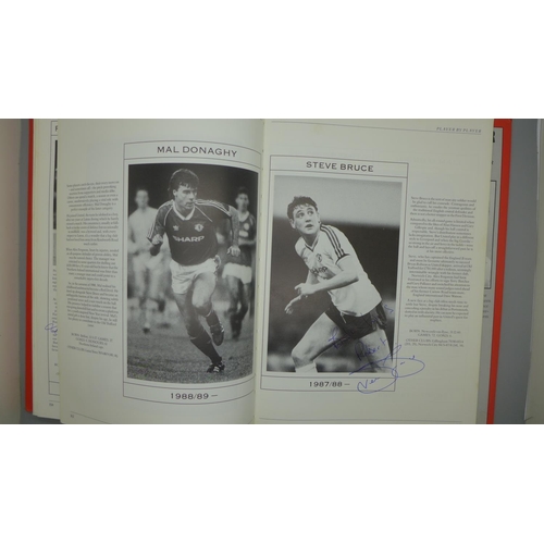 702 - Manchester United; a player by player book containing approximately 97 signatures from former player... 