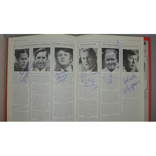 702 - Manchester United; a player by player book containing approximately 97 signatures from former player... 