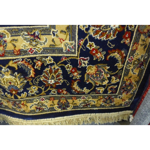 1524 - A rich blue ground Cashmere carpet with all over floral design, 300 x 200cm