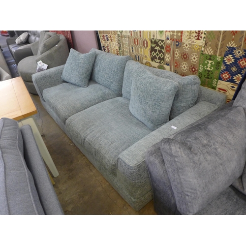 1559 - A light grey flecked, textured weave three seater sofa