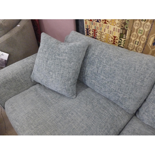 1559 - A light grey flecked, textured weave three seater sofa