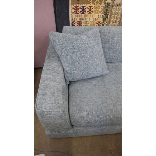 1559 - A light grey flecked, textured weave three seater sofa