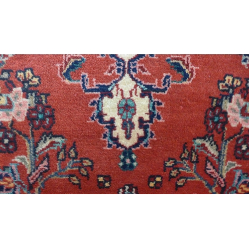 1599 - A red ground Persian Hamadan runner with floral design