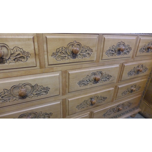 1648 - A pine carved twelve drawer chest