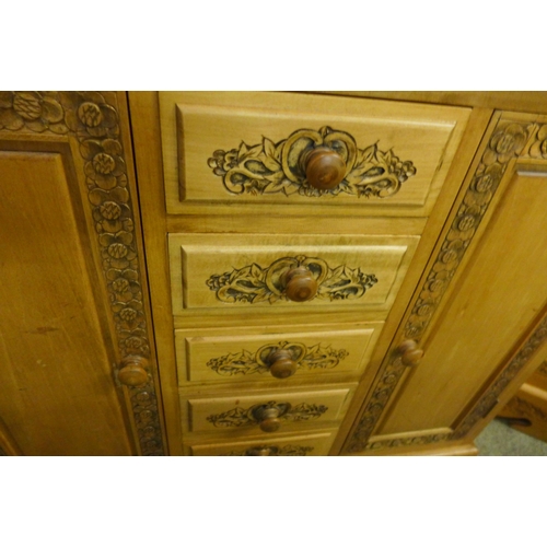 1658 - A pine carved two door, five drawer sideboard