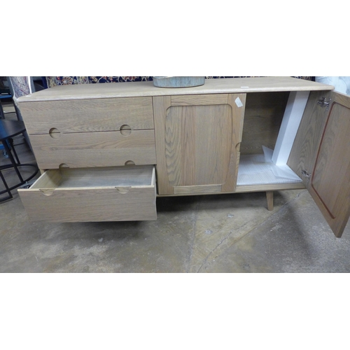 1525 - A grey oiled oak three drawer, two door sideboard