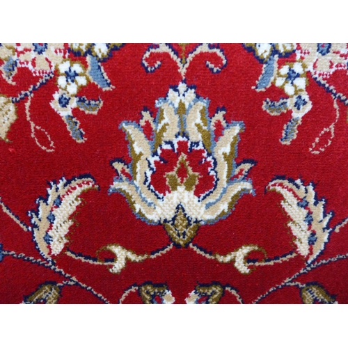 1620a - A full pile rich red ground Cashmere carpet, all over floral design, 300cm x 200cm