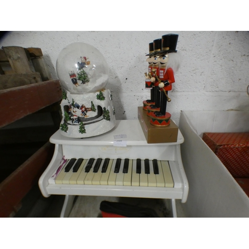 2077 - Children's piano with snow globe and festive nutcracker