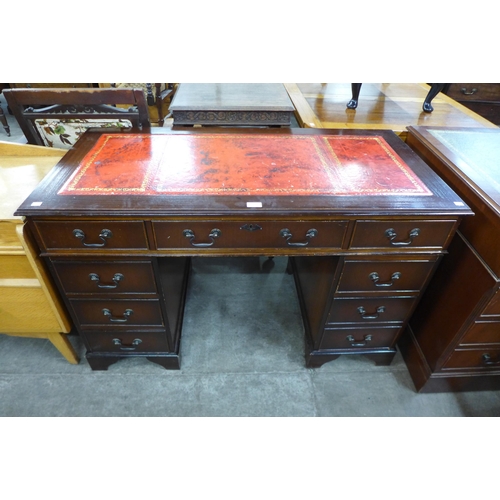 90 - A mahogany and red leather topped pedestal desk