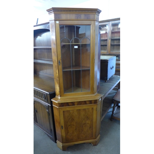 138 - A yew wood freestanding corner cabinet