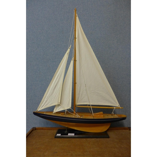 329 - A model yacht on stand