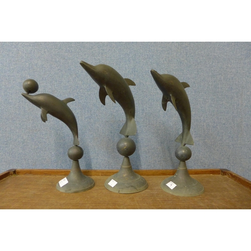 306 - Three brass dolphin ornaments