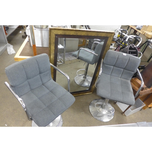 2307 - Two grey fabric padded bar stools and an ornate 1m x 80cm mantle mirror