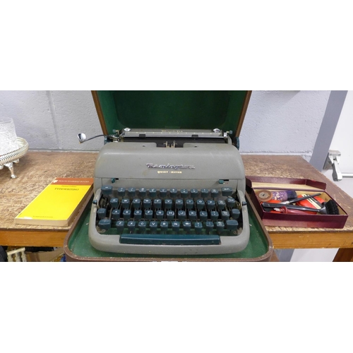 1047 - A Remington Quiet-Riter typewriter, accessories and book **PLEASE NOTE THIS LOT IS NOT ELIGIBLE FOR ... 