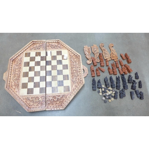 1079 - A games box with four legs and a carved chess set **PLEASE NOTE THIS LOT IS NOT ELIGIBLE FOR POSTING... 