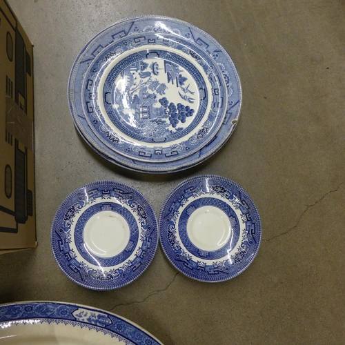 1084 - A box of blue and white china including cups, bowls, saucers and a large meat plate **PLEASE NOTE TH... 