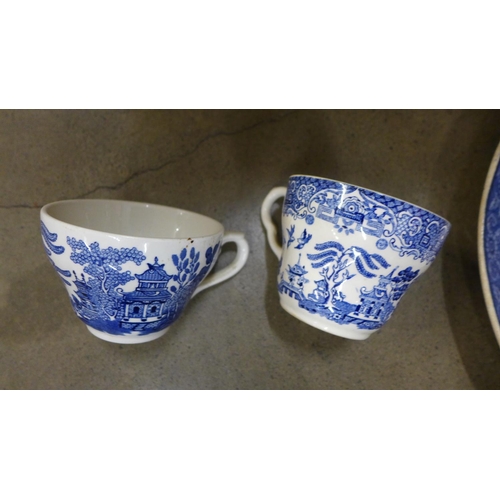 1084 - A box of blue and white china including cups, bowls, saucers and a large meat plate **PLEASE NOTE TH... 