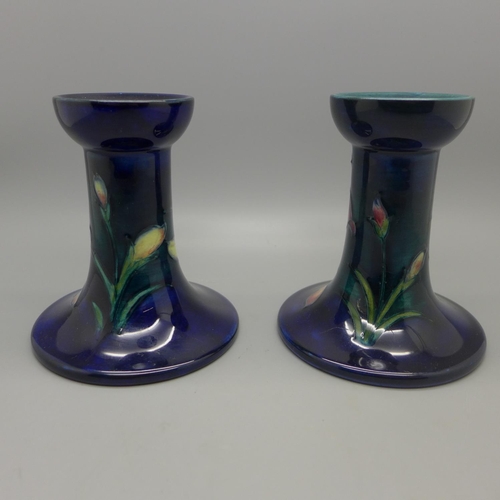 610 - A pair of Moorcroft candlesticks, 10.5cm