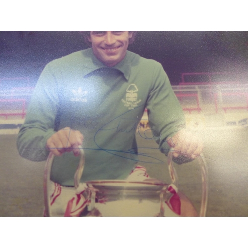 614 - A signed Peter Shilton photograph in Nottingham Forest kit, taken with the European Cup, framed