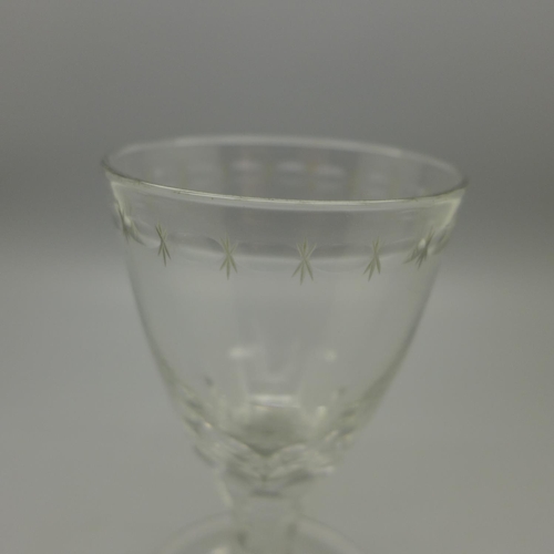 643 - A large round funnel bowl wine glass, petal faceting to bowl, with faceted stem and flared foot with... 