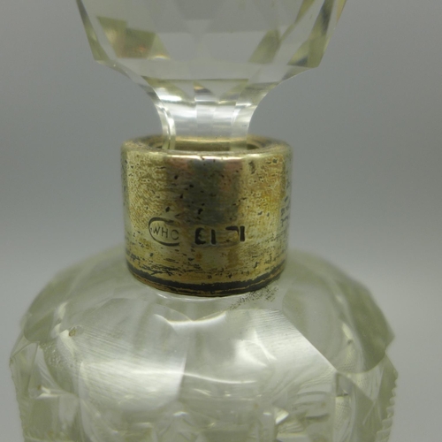 644 - A large cut glass perfume bottle with silver collar