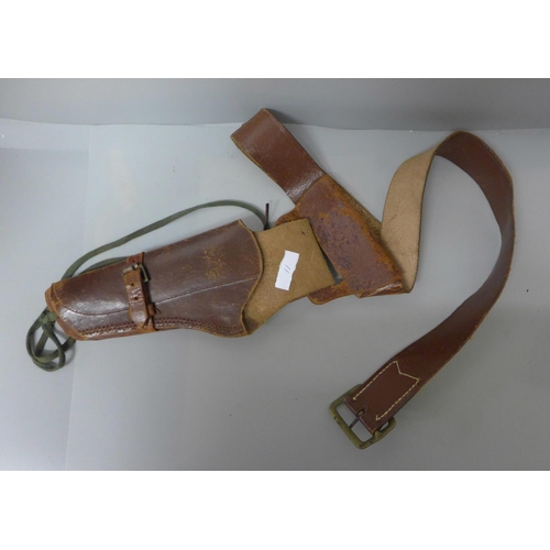 670 - A leather gun holster and belt