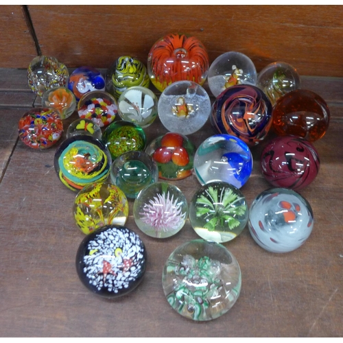 684 - A collection of twenty-six glass paperweights