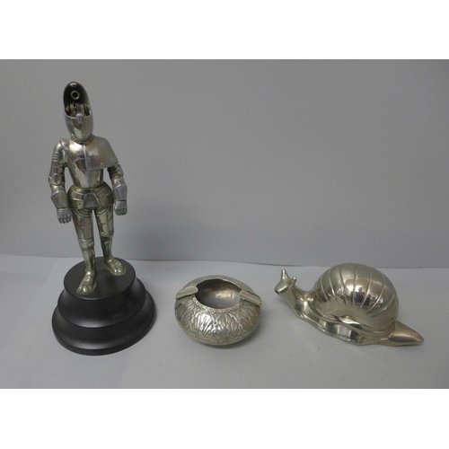 716 - A novelty table lighter in the form of a Knight, a novelty ashtray in the form of a snail and a whit... 