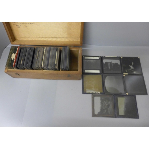 717 - A wooden box with seventy assorted magic lantern slides