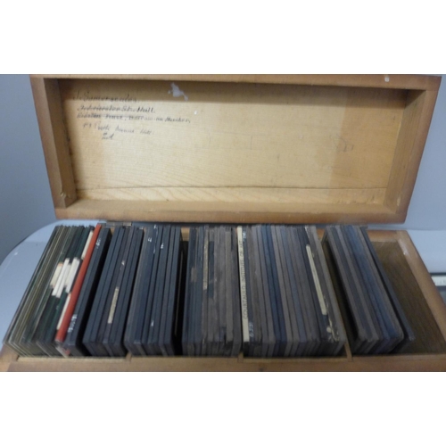 717 - A wooden box with seventy assorted magic lantern slides