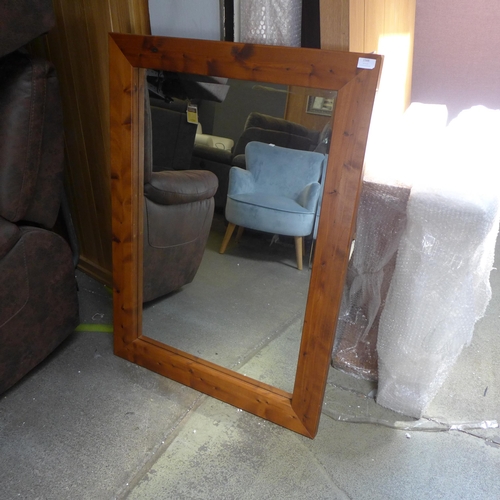 1566 - A stained pine framed mirror