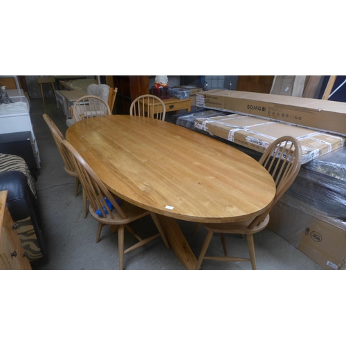 1676 - An oak large oval dining table and a set of five dining chairs