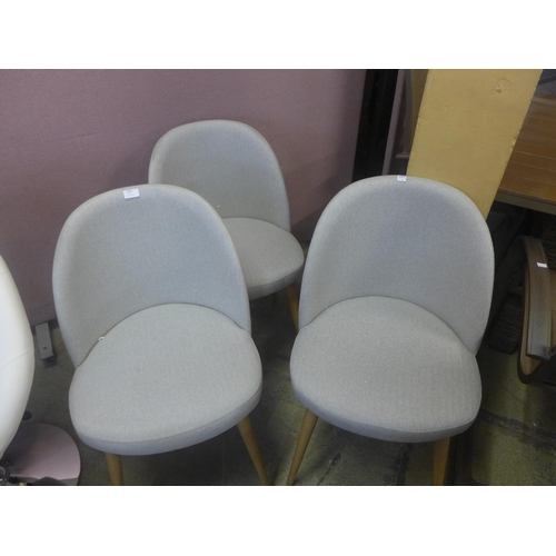 1694 - A set of three light grey fabric and oak legged side chairs