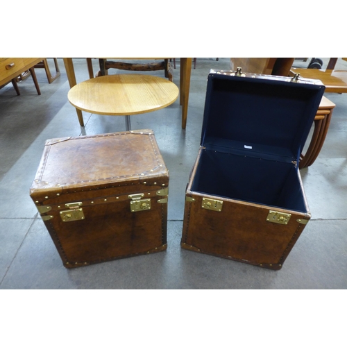 10 - A pair of chestnut brown leather and brass mounted trunks