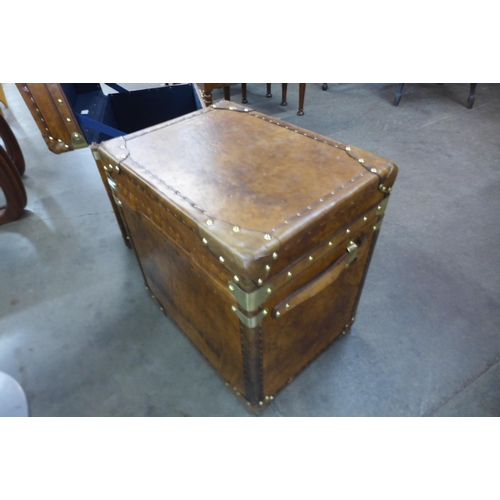 10 - A pair of chestnut brown leather and brass mounted trunks