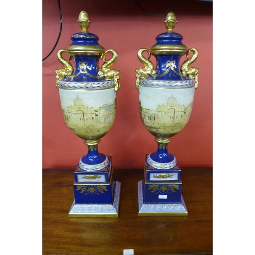 104 - A pair of large Italian style cobalt blue porcelain vases and covers, decorated with a view of St. P... 