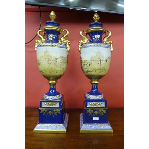 104 - A pair of large Italian style cobalt blue porcelain vases and covers, decorated with a view of St. P... 