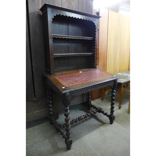 107 - A 19th Century French carved oak barleytwist writing table/bookcase