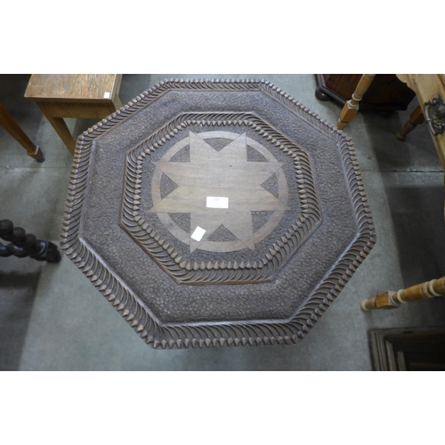 108 - A cast iron based table with later associated carved hardwood top