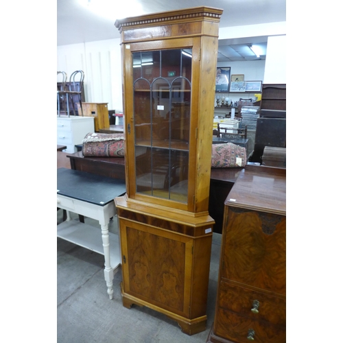 138 - A yew wood freestanding corner cabinet