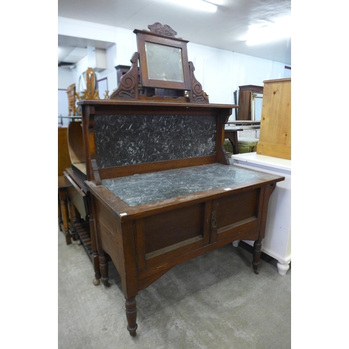 141 - A Victorian oak and marble topped washstand