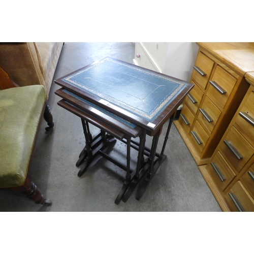 148 - A mahogany and blue leather topped nest of tables