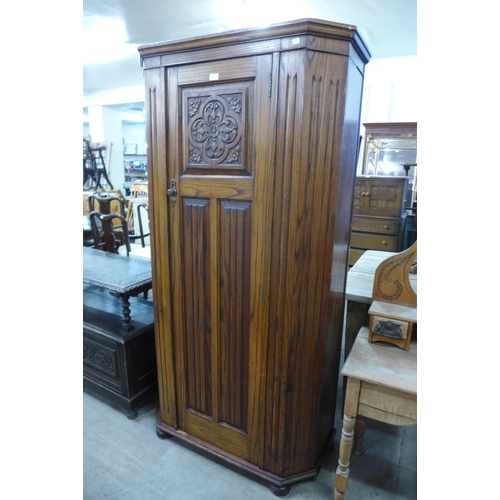 150 - A carved oak hall robe