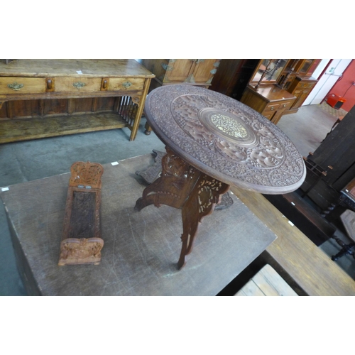 155 - An Anglo-Indian hardwood occasional table, a carved mirror and book slide