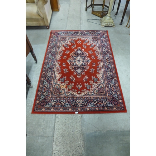 164 - A red ground rug