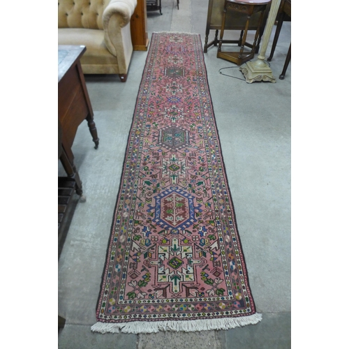 165 - A Persian pink ground runner rug, 384 x 78cms