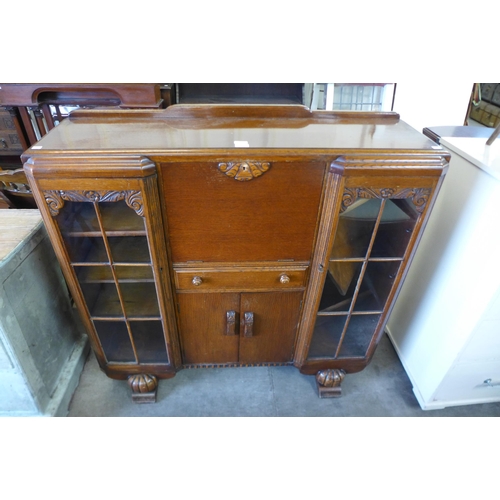 174 - A carved oak side by side bookcase