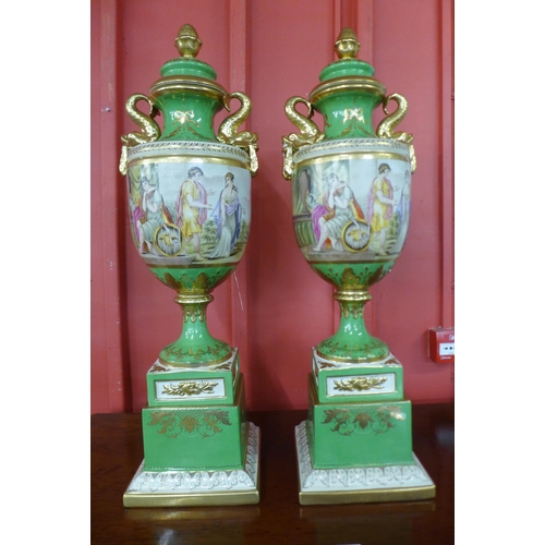 22 - A pair of Italian style green porcelain and gilt vases and covers, decorated with romantic scenes